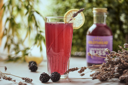 Goldthread Plant-Based Tonics Lavender Lemon Tonic Cocktail garnished with lemons and blackberries