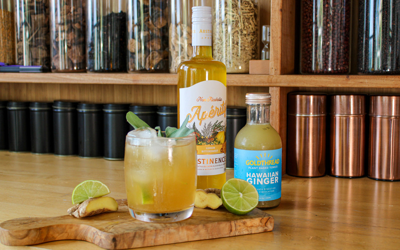 Goldthread Hawaiian Ginger Tonic and Abstinence Spirits Lemon Aperitif with cocktail and lime wedges, sage, and ginger