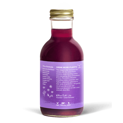 A glass bottle with a gold cap containing 10.5 fl oz (300 ml) of purple liquid. The purple label identifies the drink as Goldthread's Lavender Bliss plant-based tonic and features text reading "Calm Nerves and Reduce Stress".