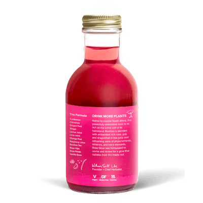 A glass bottle with a gold cap containing 10.5 fl oz (300 ml) of pink liquid. The pink label identifies the drink as Goldthread's Rose Glow plant-based tonic and features text reading "Renew and Restore with Antioxidants".