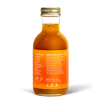 A glass bottle with a gold cap containing 10.5 fl oz (300 ml) of orange liquid. The orange label identifies the drink as Goldthread's Turmeric Radiance plant-based tonic and features text reading "Reduce Inflammation and Optimize Digestion".